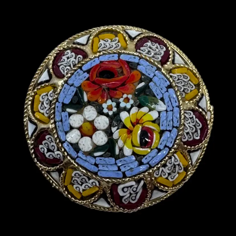 Vintage Italian micro-mosaic floral brooch in a gold-toned setting.