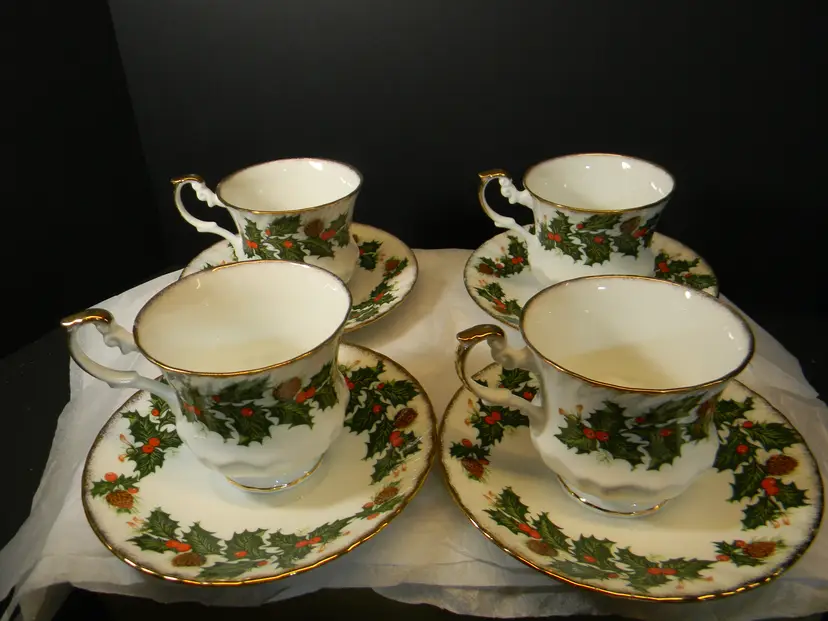 Christmas Rosina Bone Fine China from England Set of 4, scalloped edging on the saucer and cup and saucer has gold edging. (cup is 3" x 3" saucer is 5 1/2" X 3/4" High)