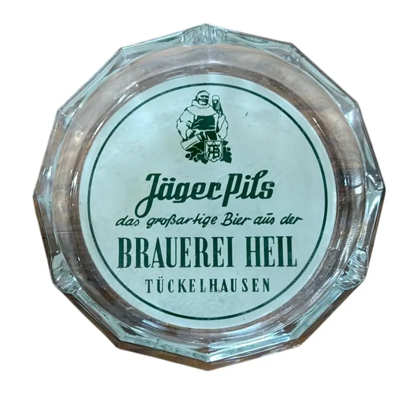 vintage glass ashtray featuring the branding for Jäger Pils beer from Brauerei Heil in Tückelhausen, Germany.