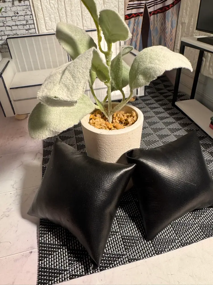 Flower And Two Black Leather Pillows