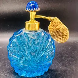 105. vintage I.W. Rice blue glass perfume bottle with an atomizer.