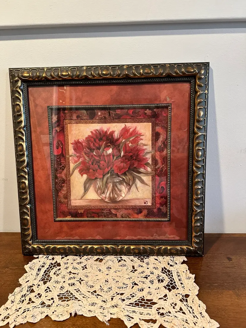 Beautiful Framed picture Of Red Flowers In a Glass vase.  Beautiful vibrant colors would look great over a Buffet or gallery wall.  Artist is Su Yue Lee.  Size: 19” X 19”