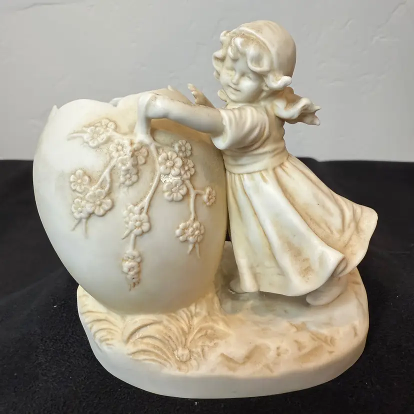 Bisque Figure of Girl With Open Egg