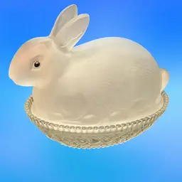 Vintage frosted satin glass bunny lidded candy dish, often referred to as a "bunny on a nest" or "nesting rabbit” LESmith?  Easter Bunny , Rabbit figure serving as the lid, sitting on a basket-weave patterned base. Commonly used as a candy dish, trinket box, or Easter decoration.  Dimensions: Approximately 4 inches tall and 4.5 inches long