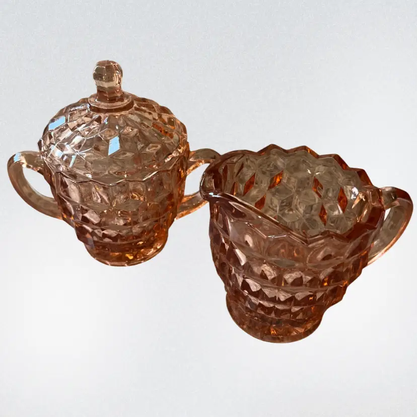 Pink glass sugar bowl with lid and creamer pitcher, Indiana Glass Peach Colony pattern. Circa 1950-1960