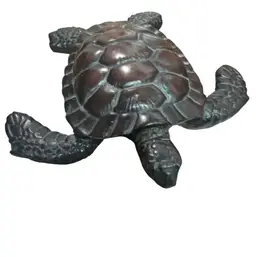 A decorative loggerhead sea turtle figurine, possibly resin , Or Wood..4” Long