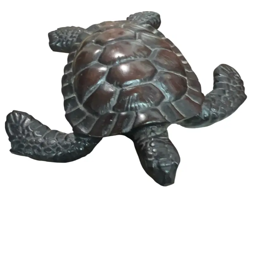 A decorative loggerhead sea turtle figurine, possibly resin , Or Wood..4” Long