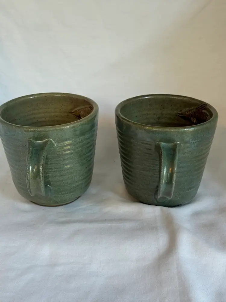 Set Of Two Pottery Mugs Made In Cameroon W/Embossed Fish Design On The Mug Interior.  Marked.