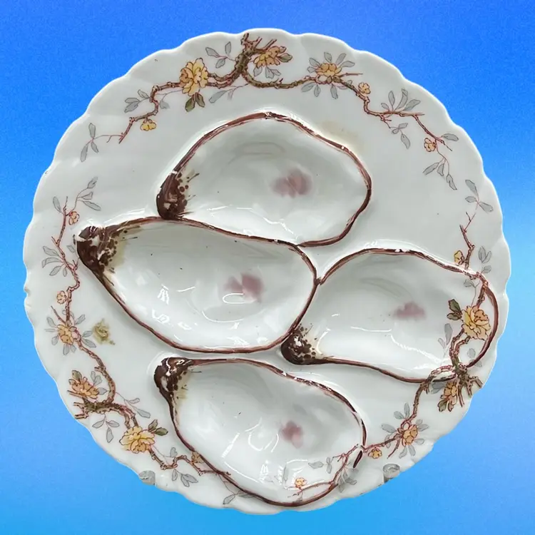 Antique Haviland & Co. Limoges porcelain oyster plate with floral decoration.