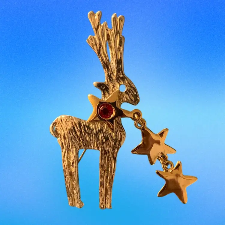 Gold Tone Reindeer With Two Attached Dangling Stars And A Red Rhinestone
