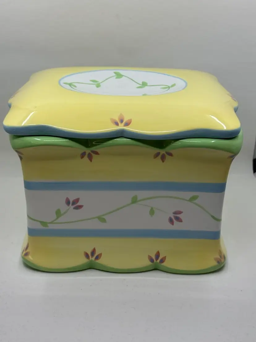 Yellow ceramic canister with floral vine design by Princess House