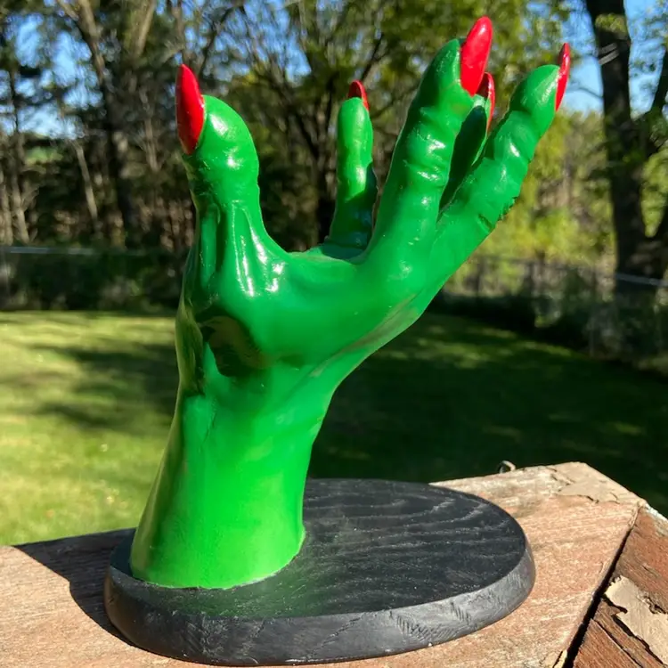Halloween Hand Display. Green Hand With Long Red Nails On A Black Stand. Plastic. Made In China. 7”h.