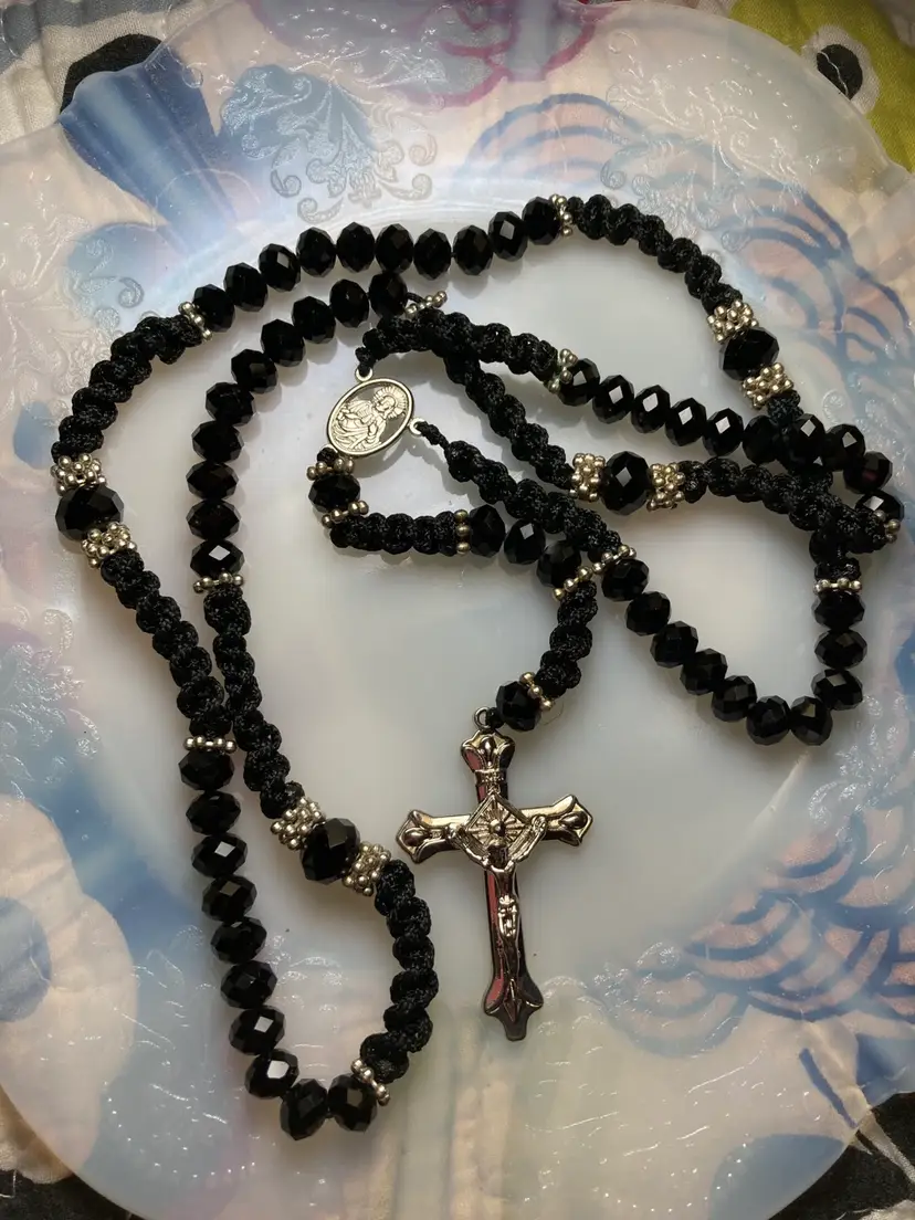 Rosary with Black Faceted Glass Beads and Silk Swirl Macramed. 
Silver Tone Cross Crucifix and Spacer Beads. 
This Is An ELEGANT Rosary!