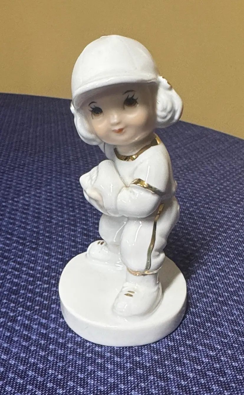 Porcelain girl playing baseball pitcher/catcher white with gold accents 4.25”