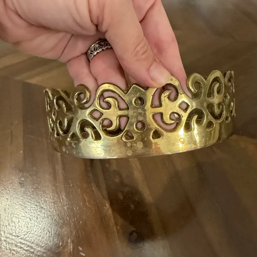 This is a vintage pierced brass filigree candle holder or display collar ring.