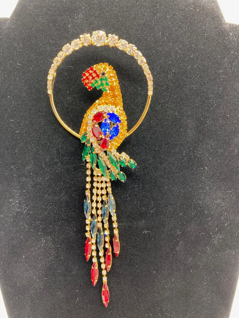 NOS parrot brooch with multicolored rhinestone crystals and a dangling tail.