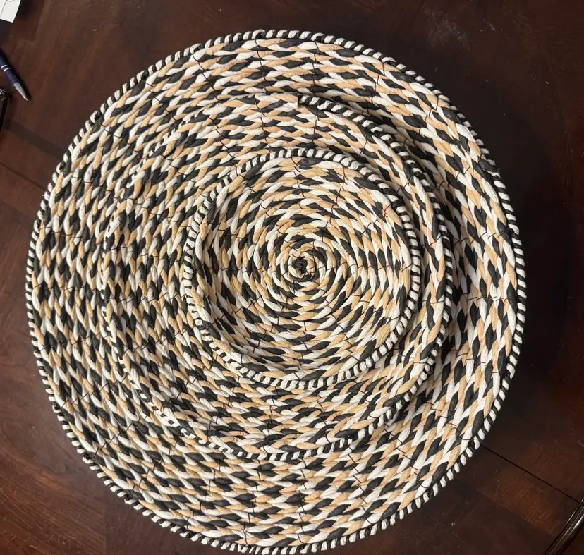 Set Of Three Woven Tan, White And Black Shallow Baskets Encased In Wire.