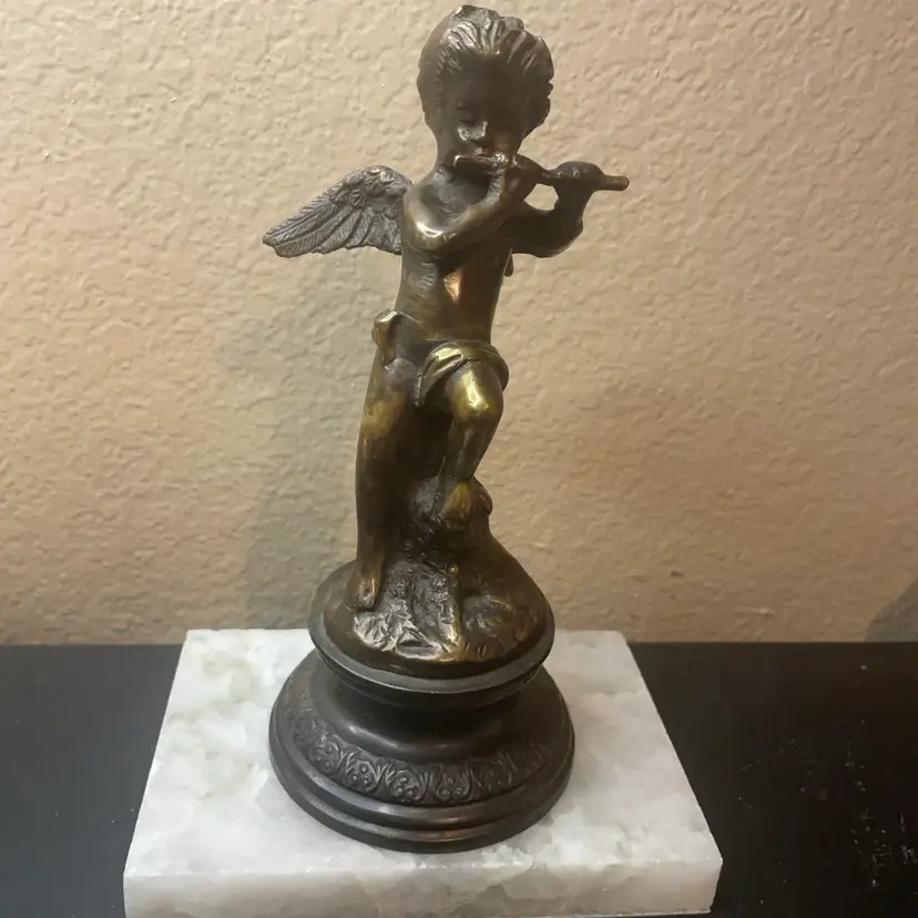 Art Nouveau 8” bronzed cherub angel playing a flute mounted on a round pedestal from European Fleamarket