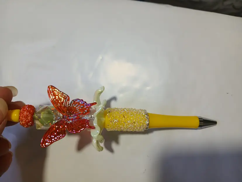 Red butterfly yellow pen
