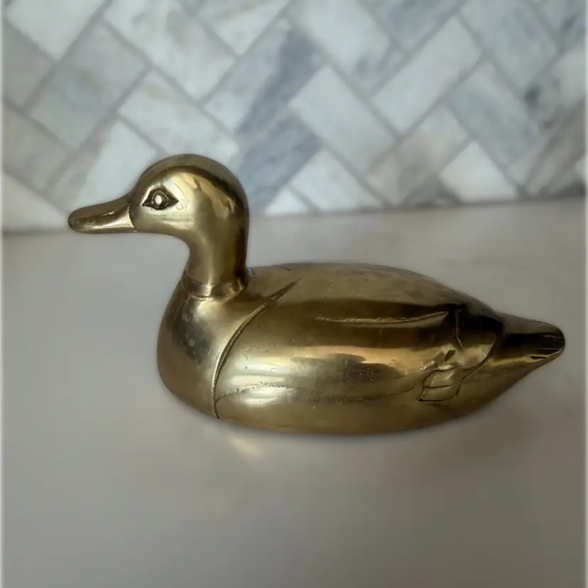 A mid-century solid brass duck 3”x6”