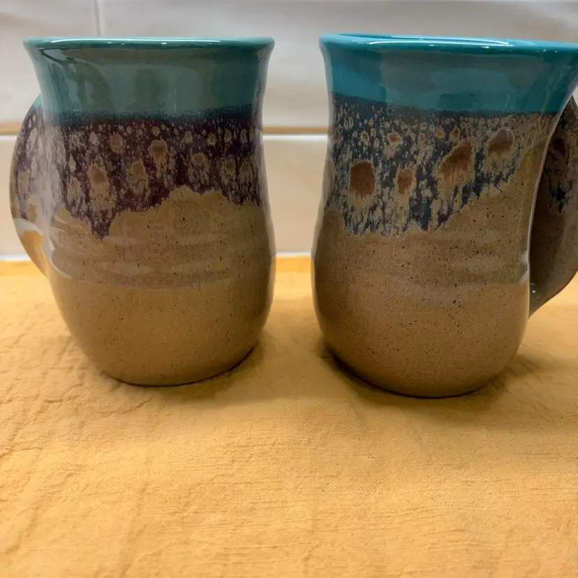 A Pair Of Pottery Coffee mugs - hand warming mug glaze finish earth tones signed