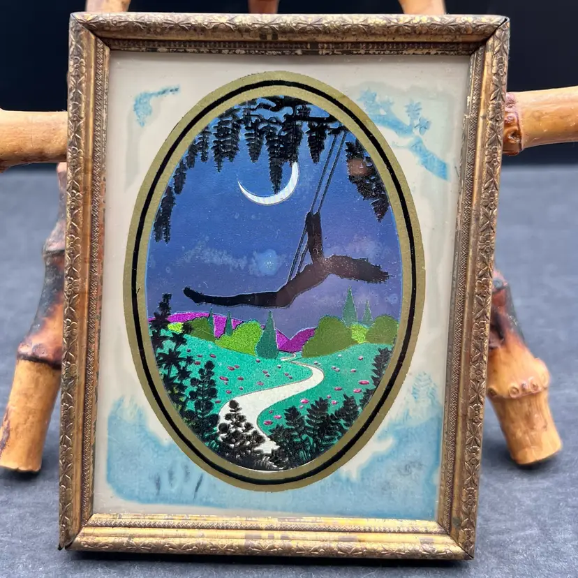 #175B Vintage Silhouette Foil Art Picture Of A Girl Swinging At Night With The Moon And Landscape Behind Her In A Gold Tone Frame And Oval Matting