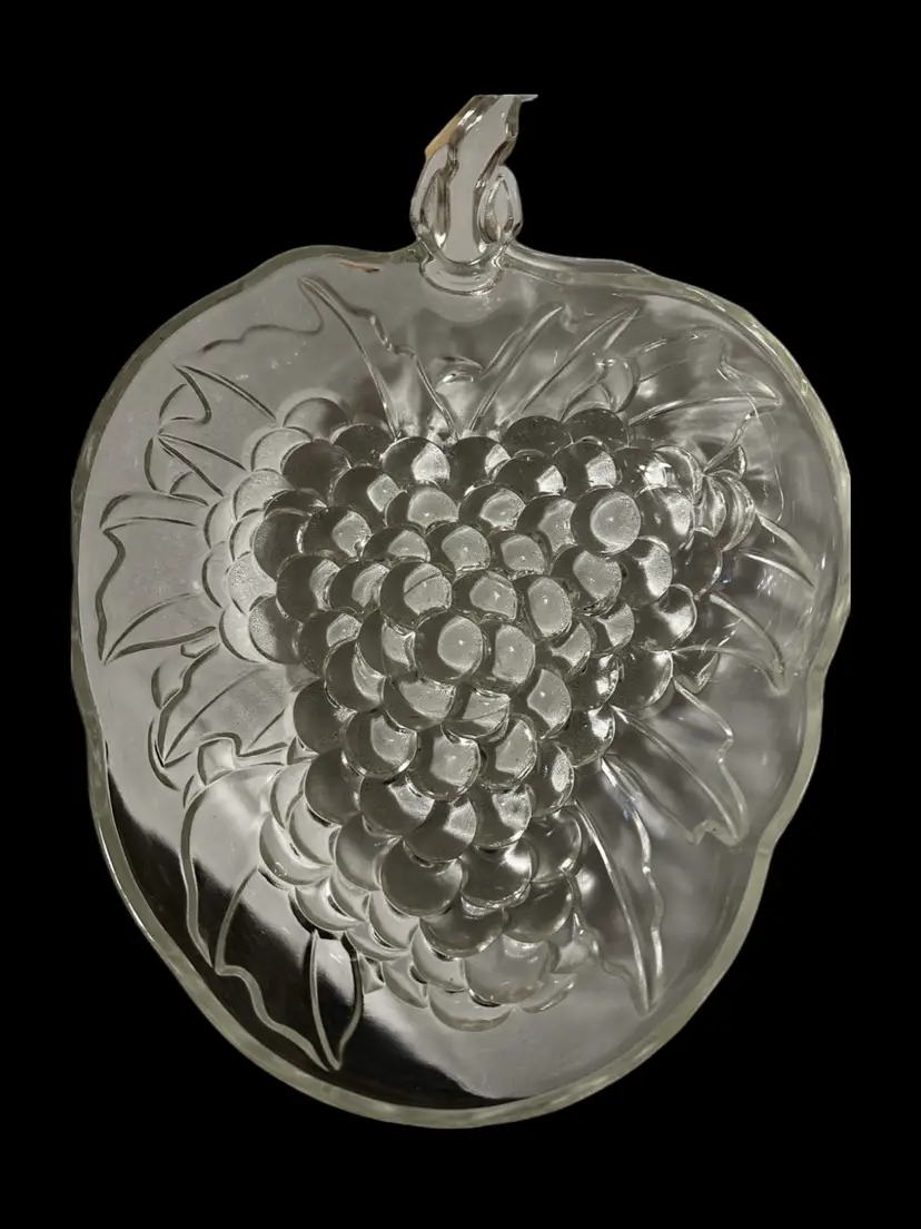 This vintage Indiana Glass fruit bowl features a raised grape cluster pattern with a stem handle