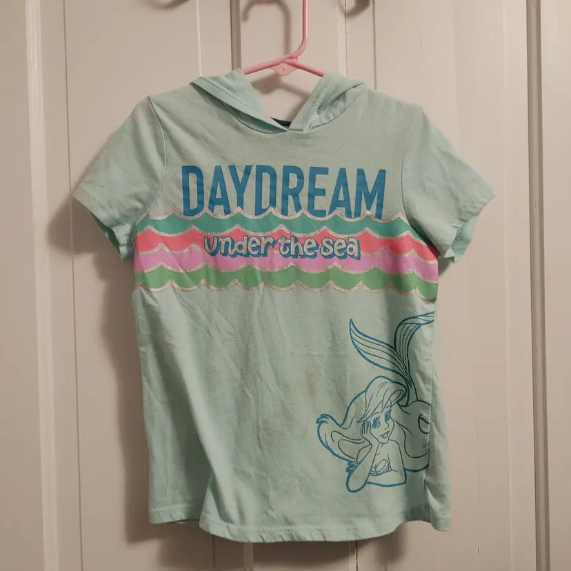 Kids- Brand: Disney. Size 7. Little Mermaid tee. Material- 60% cotton, 40% polyester. Stain on front.