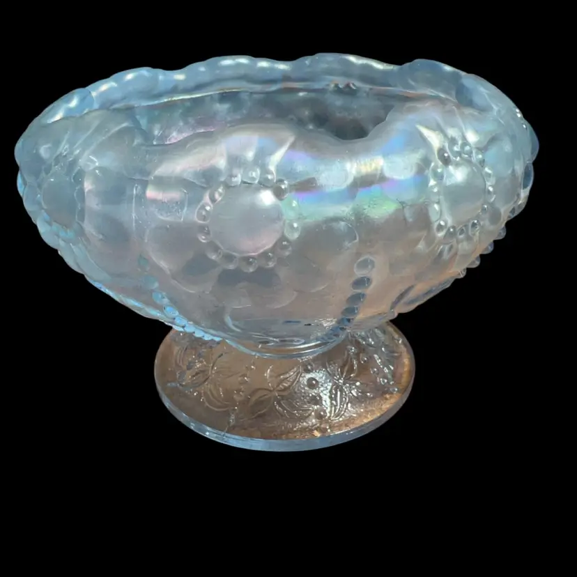 This is a vintage Fenton ice blue iridescent footed glass bowl. 3x4