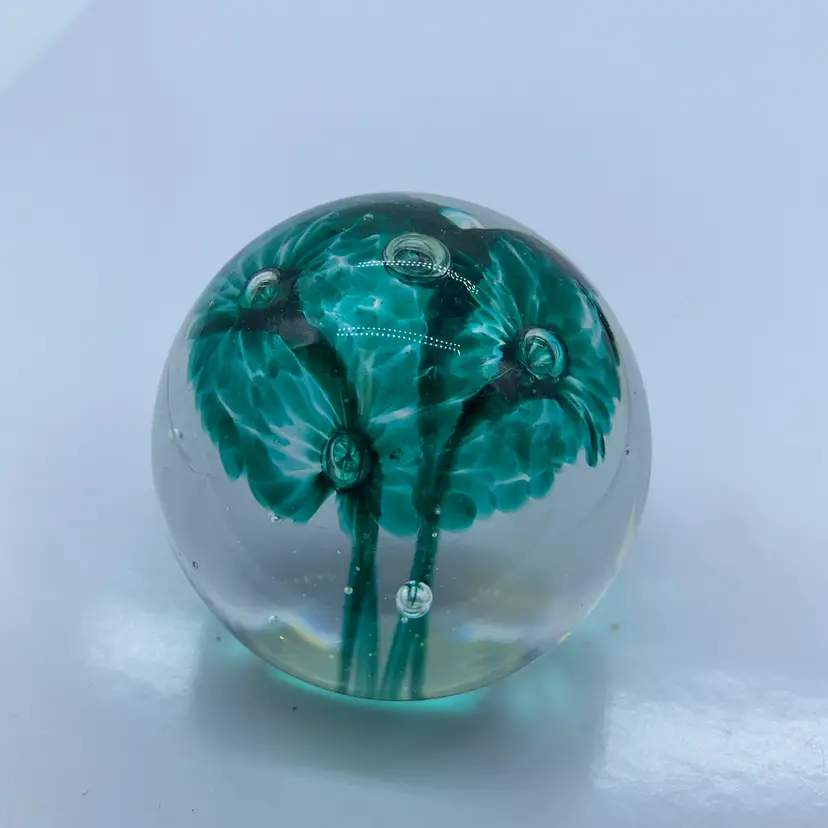 #0086 A handmade Guernsey Island Studio Glass paperweight featuring green flowers and original label.