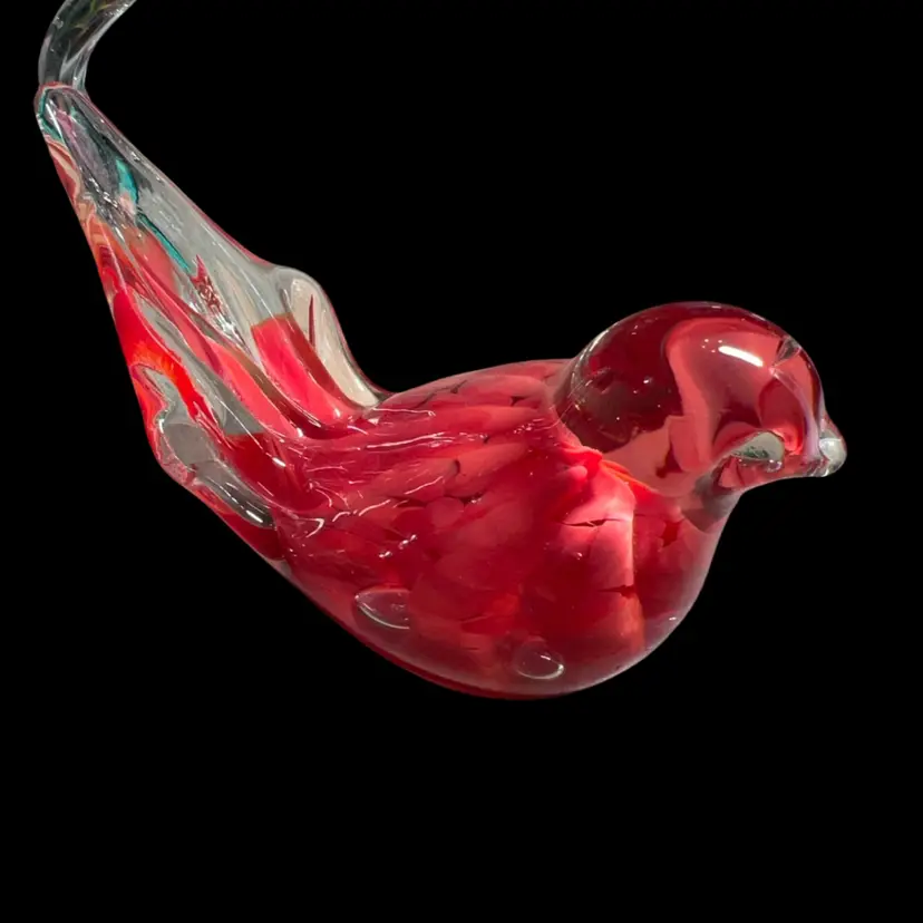 Red And Clear hand-blown art glass bird paperweight created by Maude and Bob St. Clair. Bob St. Clair and his wife Maude opened their independent studio, the St. Clair House of Glass, in West Elwood, Indiana, in 1971. They specialized in collectible paperweights and small glass novelties featuring internal swirls, controlled bubbles, and vibrant floral motifs. Their pieces are typically signed or stamped on the flat, polished bottom with "Maude and Bob St. Clair" along with the year it was made