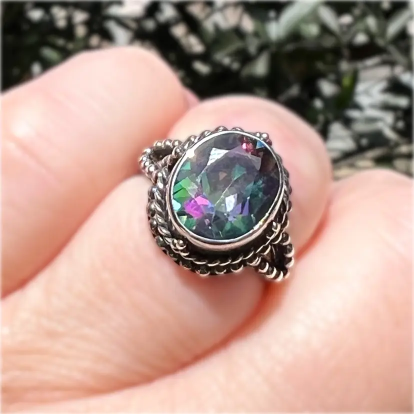Mystic Topaz Oval Cut Size 7 Ring. Beaded Silver Setting. Stamped “925”.