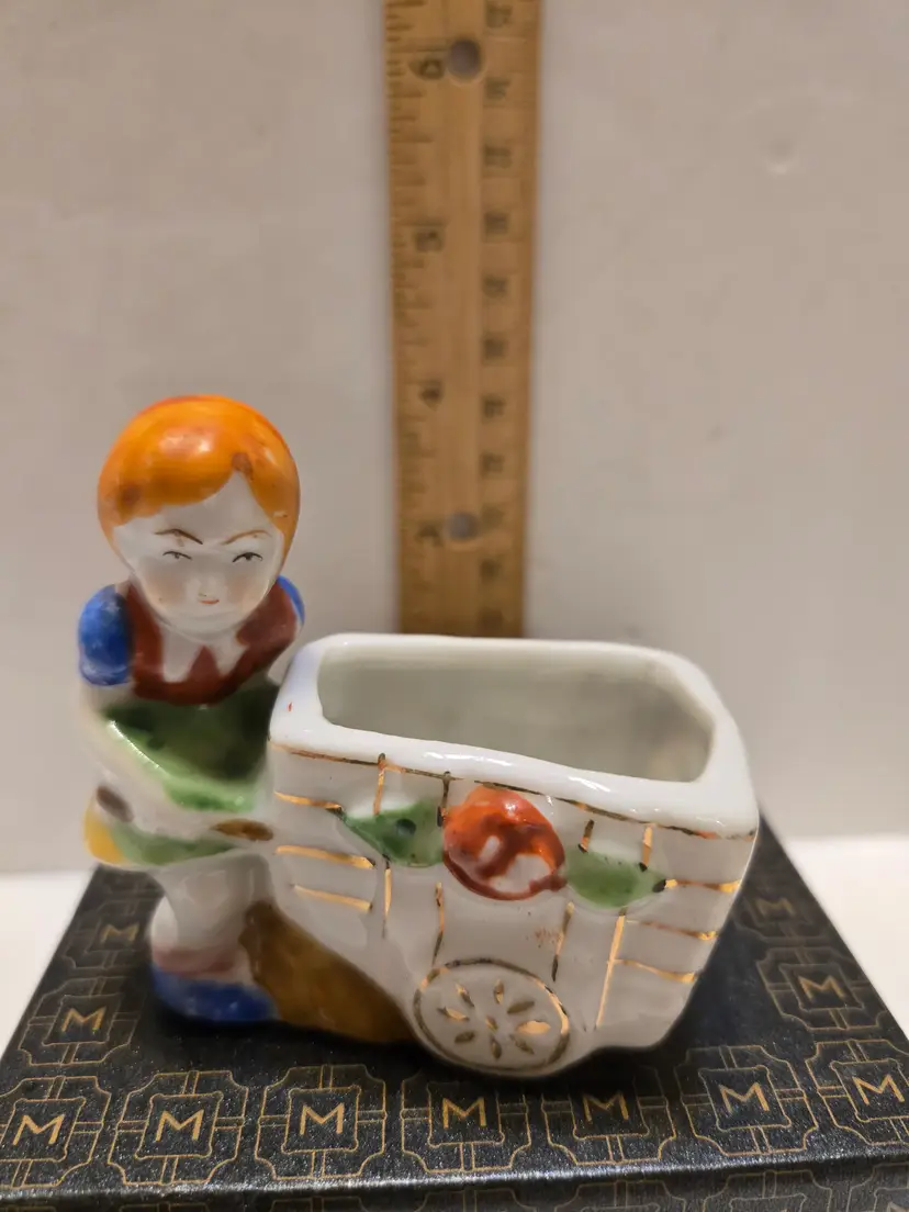 Occupied Japan Porcelain Girl with Fruit Cart Planter Figurine Description