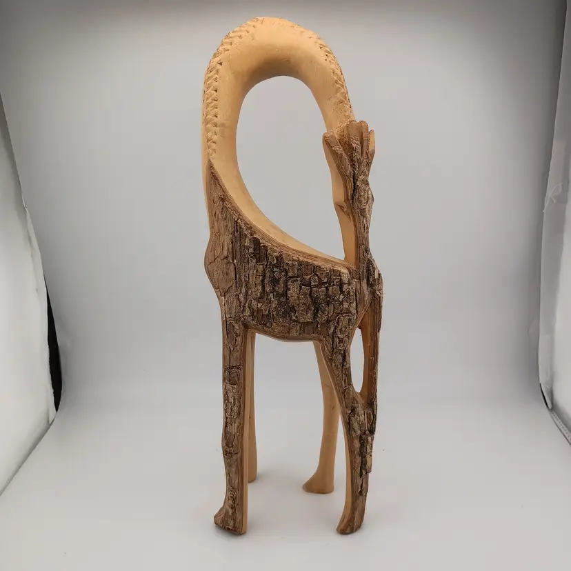 Handcarved wooden giraffe with raw bark