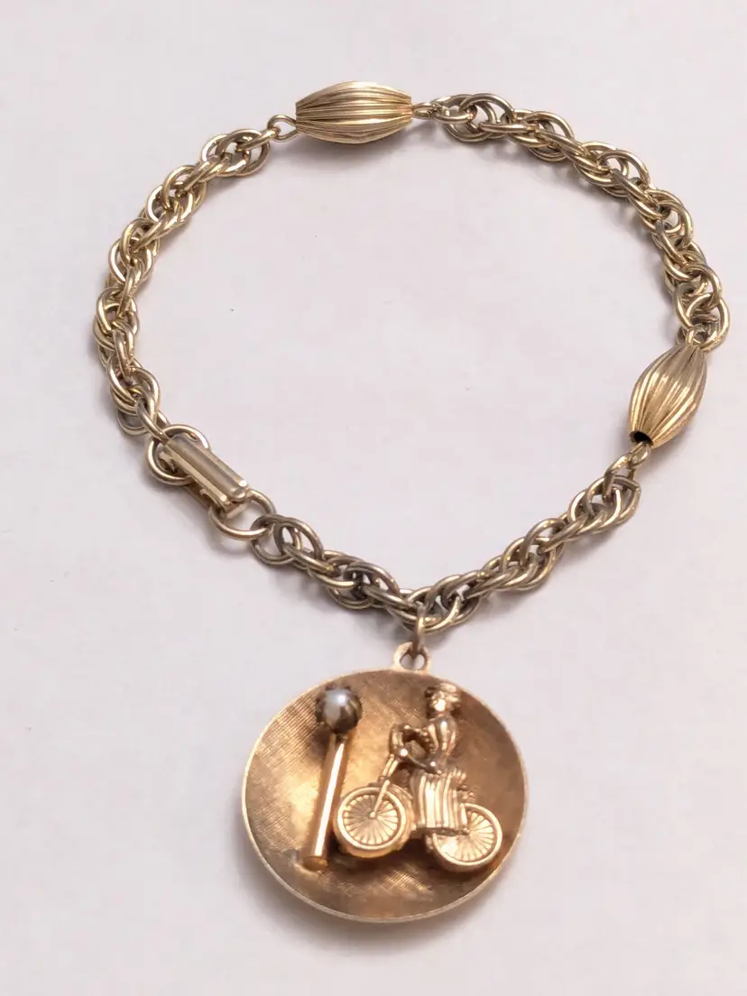 Vintage Mid Century Gold Tone Lady on Bicycle Charm Bracelet