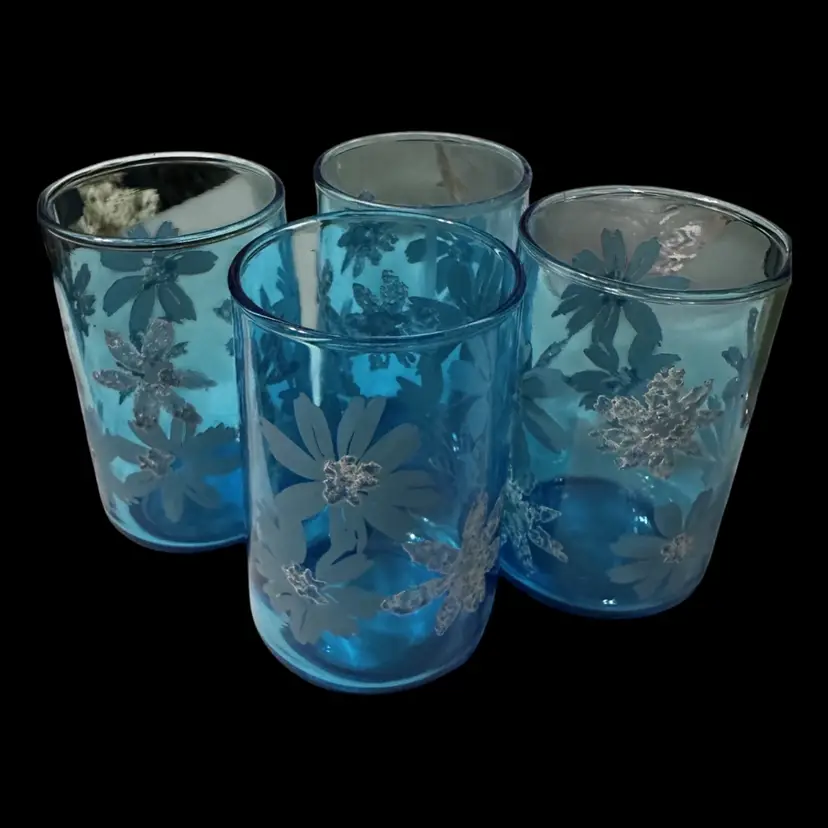 Vintage Libbey blue tumblers with a raised white floral design.