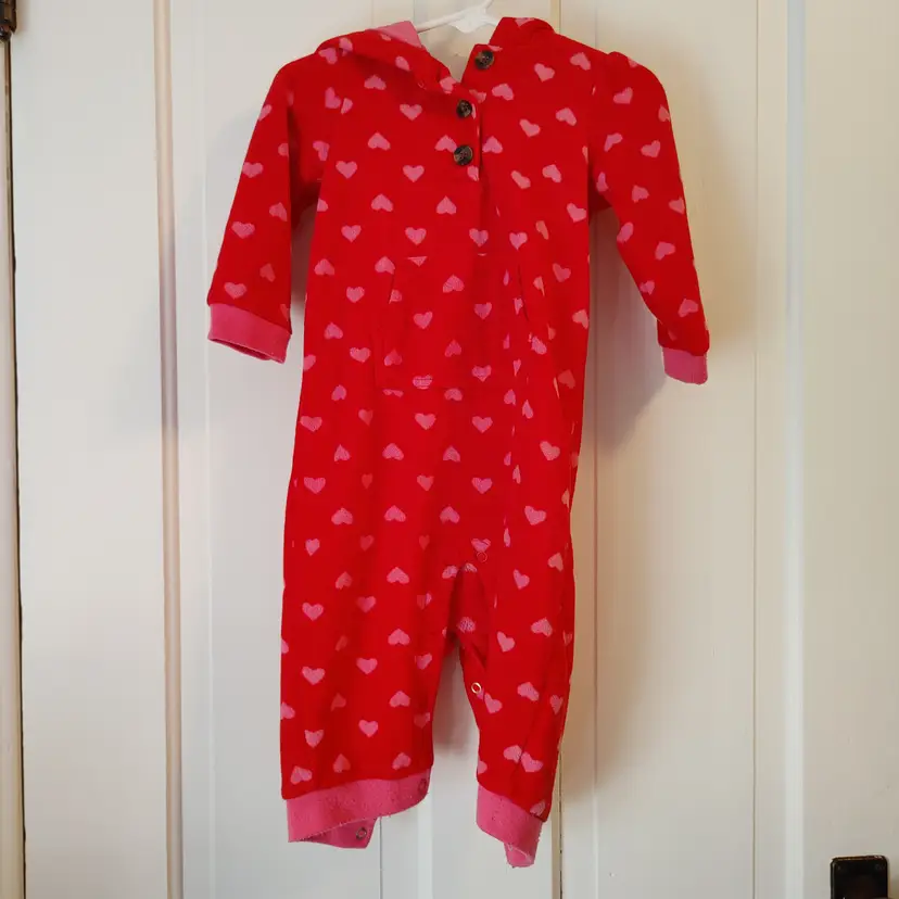 Kids- Brand: Carters. Size 12 months. Red with pink hearts. Material- Body 100% Polyester, Lining 100% cotton. No callouts.