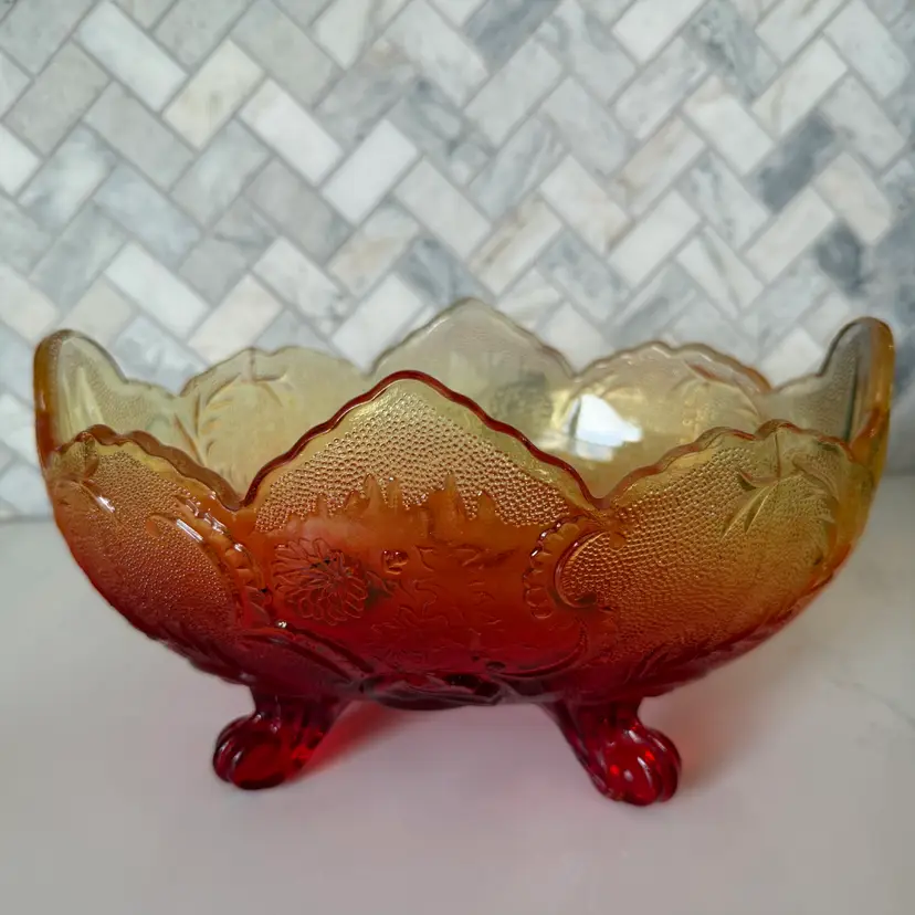 A Jeannette Glass Lombardi pattern iridescent carnival glass footed bowl. Some Color Loss On Bottom