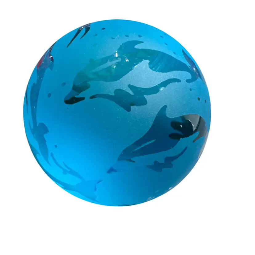 vintage Glass Baron Dolphin and Ocean Frosted Glass Paperweight/Globe (c. 1996), featuring a frosted aqua-blue surface with etched or embossed silhouettes of dolphins and marine life