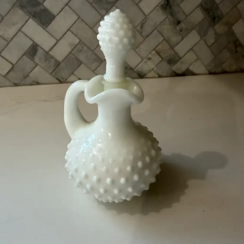 Avon white milk glass hobnail cruet bottle with a matching stopper.