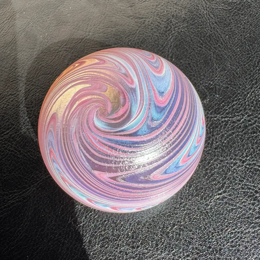 #0075 A signed studio art glass paperweight featuring fumed glass Pink swirls.