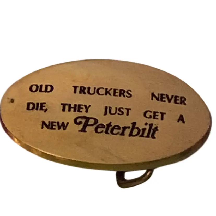 Vintage Solid Brass belt buckle featuring the engraved text "OLD TRUCKERS NEVER DIE, THEY JUST GET A NEW Peterbilt”