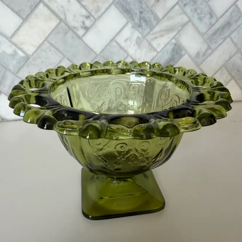 Vintage green Indiana Glass footed candy dish with lace rim. 3 Inches Tall By 5 Inches Wide.