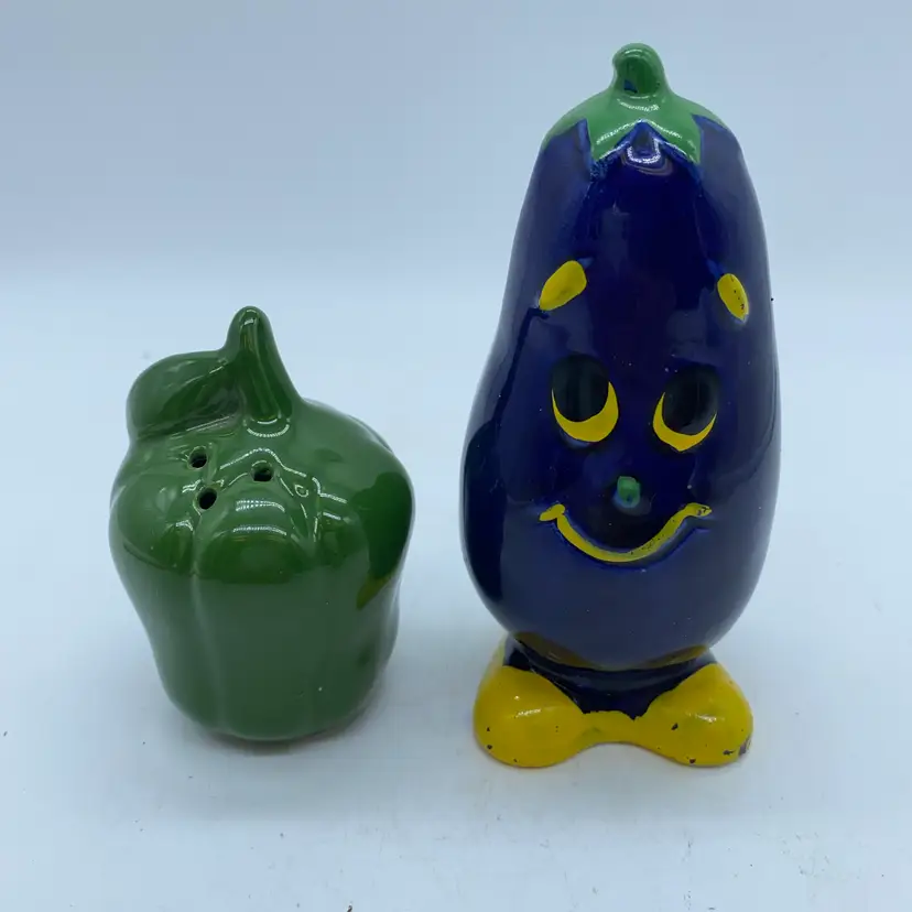 Vintage anthropomorphic eggplant and bell pepper ceramic salt and pepper shakers.