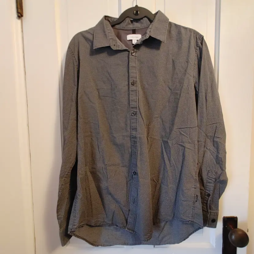Men's Top- Brand: Calvin Klein. Size Medium. Black houndstooth top. 100% cotton. No condition issues.