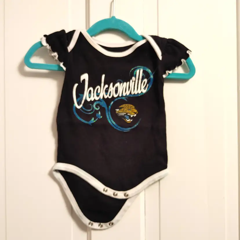Kids- Brand: NFL. Size 3-6 months. Jacksonville Jaguars onesie. Material- 100% cotton. No callouts.