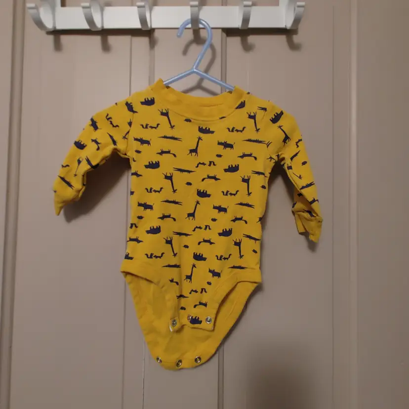 Kids- Brand: Carter's. Size 6 months. Yellow one piece outfit with animals. Material- 100% cotton.  No callouts.
