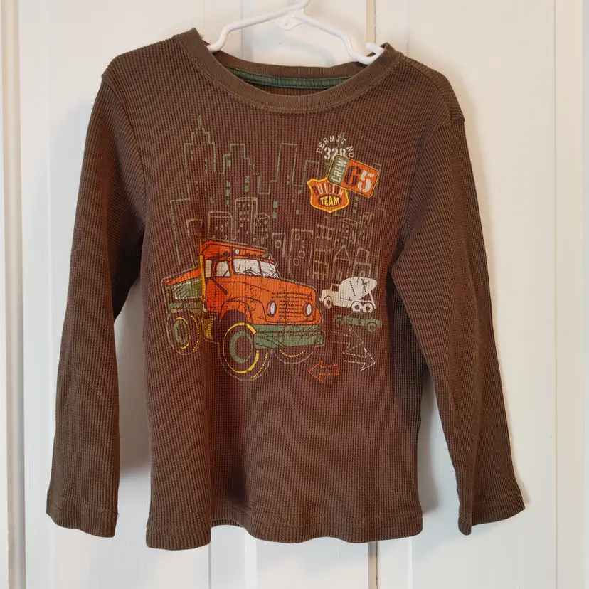 Kids- Brand: Wonder Kids. Size 5T. Brown shirt with trucks. Material: 60% cotton, 40% polyester. No callouts.