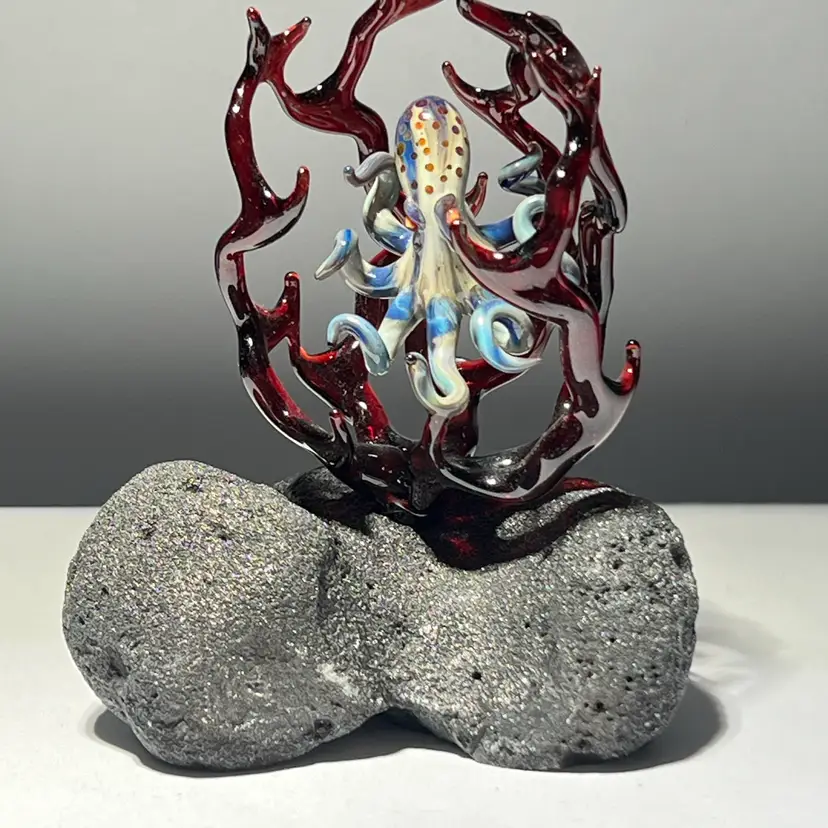 Lindquist Glass Art Octopus surrounded in Coral on Display rock pedestal