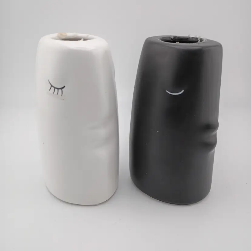 Pair of ceramic face candlholders or bud vases